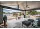 Inviting covered patio featuring comfortable seating and views of landscaped backyard at 9039 N Concho Ln, Phoenix, AZ 85028