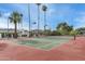 Tennis court with lights and lush trees at 9039 N Concho Ln, Phoenix, AZ 85028
