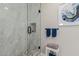 Modern bathroom featuring a glass-enclosed shower with stone flooring at 10030 W Indian School Rd # 215, Phoenix, AZ 85037