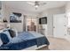 Bedroom with a queen bed, carpeted floors, and a glass door overlooking a balcony at 10030 W Indian School Rd # 215, Phoenix, AZ 85037