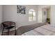 This cozy bedroom has a chair, natural light, and stylish decor to promote relaxation at 10030 W Indian School Rd # 215, Phoenix, AZ 85037