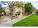 Condo building with inviting picnic area, grill, and green lawn space for residents to enjoy at 10030 W Indian School Rd # 215, Phoenix, AZ 85037