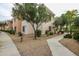 Well-maintained condo building exterior with desert landscaping and sidewalk at 10030 W Indian School Rd # 215, Phoenix, AZ 85037