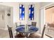 Charming dining area with glass table, stylish decor, and lots of natural light at 10030 W Indian School Rd # 215, Phoenix, AZ 85037