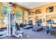 Brightly lit gym featuring windows, ceiling fans, and lots of equipment at 10030 W Indian School Rd # 215, Phoenix, AZ 85037