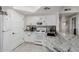Bright kitchen featuring white cabinets, stainless steel appliances, and granite countertops at 10030 W Indian School Rd # 215, Phoenix, AZ 85037