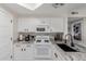 Well-lit kitchen featuring granite countertops, white cabinets, and modern appliances at 10030 W Indian School Rd # 215, Phoenix, AZ 85037