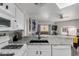 Open kitchen with a granite countertop island and stainless steel appliances overlooking dining room at 10030 W Indian School Rd # 215, Phoenix, AZ 85037