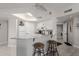 Bright kitchen featuring white cabinets, stainless steel appliances, granite countertops, and bar stool seating at 10030 W Indian School Rd # 215, Phoenix, AZ 85037