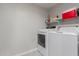 A functional laundry room is equipped with modern washer and dryer units and wire shelving at 10030 W Indian School Rd # 215, Phoenix, AZ 85037