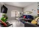 Comfortable living room with a sofa, a TV, and decorative pineapple statue at 10030 W Indian School Rd # 215, Phoenix, AZ 85037