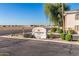 The Desert Breeze Villas community sign is enhanced with desert landscaping at 10030 W Indian School Rd # 215, Phoenix, AZ 85037