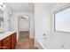 Bathroom featuring a soaking tub, window, and tile flooring at 11158 N 162Nd Dr, Surprise, AZ 85379