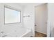 Bright bathroom featuring a soaking tub and a window at 11158 N 162Nd Dr, Surprise, AZ 85379