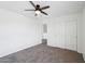 Neutral bedroom features carpet floors, a ceiling fan, and a closet with sliding doors at 11158 N 162Nd Dr, Surprise, AZ 85379