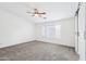 Spacious carpeted bedroom with barn door entrance to bathroom at 11158 N 162Nd Dr, Surprise, AZ 85379