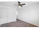 Neutral bedroom features carpet floors, a ceiling fan, and a closet with sliding doors at 11158 N 162Nd Dr, Surprise, AZ 85379