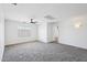 Bright and neutral room with plush carpet floors, a ceiling fan, and a window at 11158 N 162Nd Dr, Surprise, AZ 85379