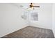 Bedroom with neutral carpet, ceiling fan, and two windows at 11158 N 162Nd Dr, Surprise, AZ 85379