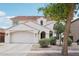 Beautiful two-story home featuring a two-car garage, arched entryway, and meticulously landscaped front yard at 11158 N 162Nd Dr, Surprise, AZ 85379
