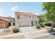 Charming two-story home featuring a well-manicured yard, two-car garage, and classic desert landscaping at 11158 N 162Nd Dr, Surprise, AZ 85379