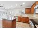 Bright kitchen featuring stainless steel appliances, an island, and dark wood cabinetry at 11158 N 162Nd Dr, Surprise, AZ 85379