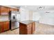 Spacious kitchen features stainless steel appliances, kitchen island, and wood cabinets at 11158 N 162Nd Dr, Surprise, AZ 85379