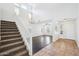 Bright, open-concept living room with high ceilings, staircase, large windows, and hardwood flooring at 11158 N 162Nd Dr, Surprise, AZ 85379