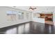 Living room with hardwood floors leads to kitchen with stainless steel appliances and wood cabinets at 11158 N 162Nd Dr, Surprise, AZ 85379