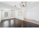 Bright living room featuring hardwood floors, ceiling fan, and arched entryway at 11158 N 162Nd Dr, Surprise, AZ 85379