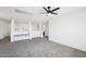 Living room area with a ceiling fan, neutral carpet, and built-in bench seating at 11158 N 162Nd Dr, Surprise, AZ 85379