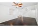 Spacious living room with dark hardwood floors, arched doorways, chandelier, and abundant natural light at 11158 N 162Nd Dr, Surprise, AZ 85379