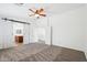 Large carpeted main bedroom with barn doors leading into the en-suite bathroom at 11158 N 162Nd Dr, Surprise, AZ 85379