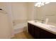 A bathroom with double sinks, a tub, tile floors, and a large mirror above the sinks at 120 W Milada Dr, Phoenix, AZ 85041