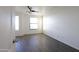 Bedroom featuring laminate floors, a ceiling fan, and large windows at 120 W Milada Dr, Phoenix, AZ 85041