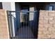 Metal gate and brick fencing at the entry way to the home at 120 W Milada Dr, Phoenix, AZ 85041