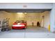 Clean and spacious garage interior featuring a red car and plenty of extra storage space at 120 W Milada Dr, Phoenix, AZ 85041