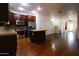 An open concept kitchen with granite countertops, stainless steel appliances, and dark wood flooring at 120 W Milada Dr, Phoenix, AZ 85041