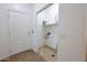 Bright laundry area with tile floor and convenient access to a utility sink at 120 W Milada Dr, Phoenix, AZ 85041