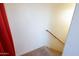 Carpeted staircase with wood railing and white walls at 120 W Milada Dr, Phoenix, AZ 85041
