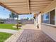 Spacious backyard featuring a covered patio, lush grass, and a fire pit, perfect for outdoor entertaining at 12201 N 22Nd Pl, Phoenix, AZ 85022