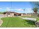 Spacious backyard featuring artificial turf, a well-manicured landscape and a paved parking area at 12201 N 22Nd Pl, Phoenix, AZ 85022