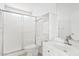Bright bathroom featuring a shower, toilet, vanity sink, and a storage cabinet, maximizing functionality at 12201 N 22Nd Pl, Phoenix, AZ 85022
