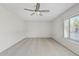 Bright bedroom with neutral carpet, light-colored walls, ceiling fan, and a window offering natural light at 12201 N 22Nd Pl, Phoenix, AZ 85022
