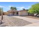 Single story home featuring a brick facade, covered patio, and desert landscaping in front at 12201 N 22Nd Pl, Phoenix, AZ 85022