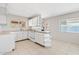 Cozy kitchen with white cabinets, a breakfast bar, and tile flooring, perfect for casual dining at 12201 N 22Nd Pl, Phoenix, AZ 85022