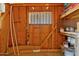 Interior storage area featuring a window with bars, and exposed wooden studs and shelves at 12201 N 22Nd Pl, Phoenix, AZ 85022