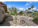 A beautifully landscaped backyard features a variety of desert plants and a brick patio at 13019 N 23Rd Pl, Phoenix, AZ 85022