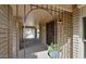 Welcoming covered entrance with brick accents, a secure iron gate, and a charming potted plant, enhancing curb appeal at 13019 N 23Rd Pl, Phoenix, AZ 85022