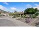 Beautifully landscaped single-story home with a tile roof, desert plants, and a charming brick mailbox, offering curb appeal at 13019 N 23Rd Pl, Phoenix, AZ 85022
